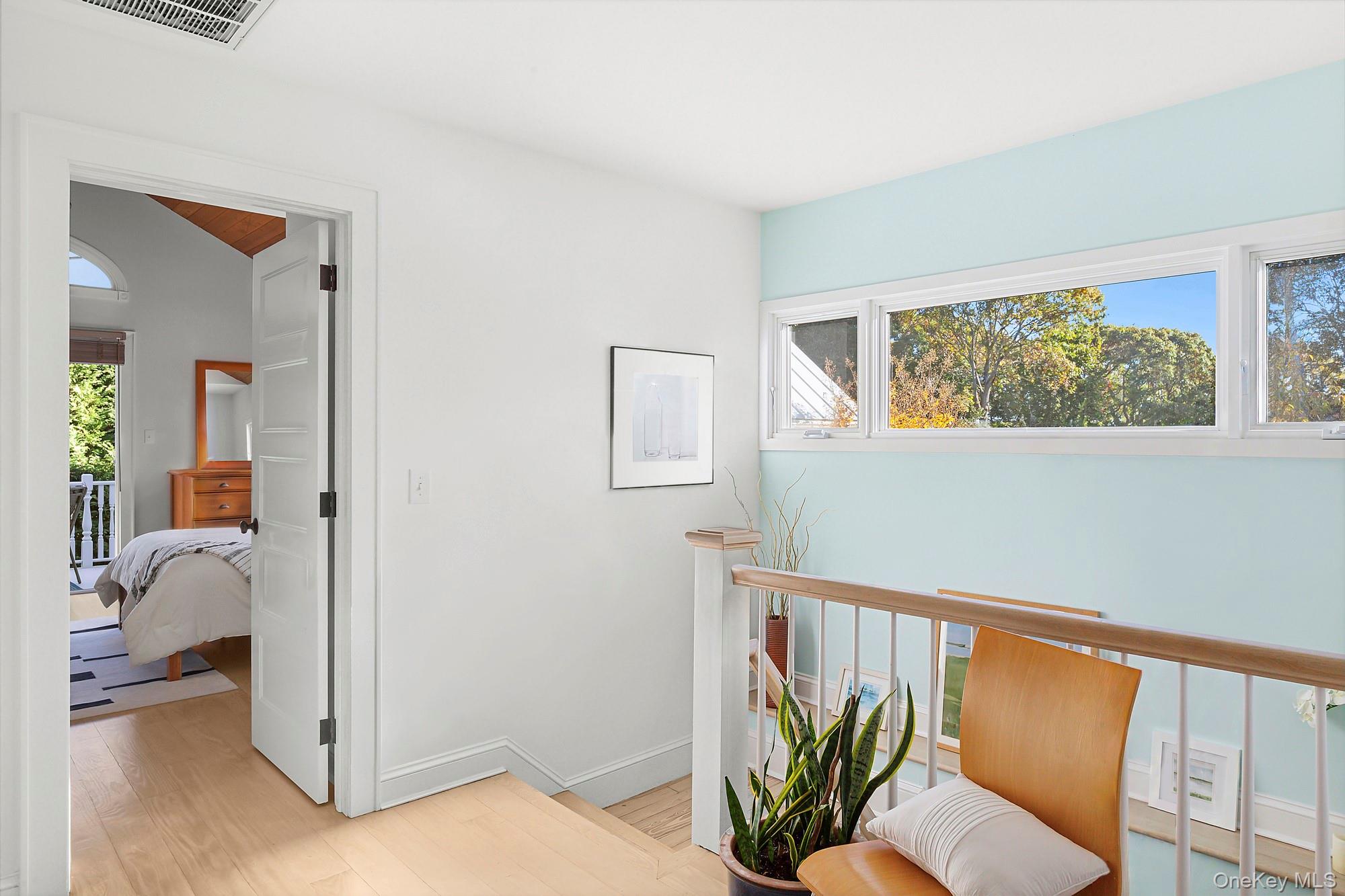 21 Cove Road Sag Harbor, NY 11963 - Photo 23 of 37 Living area with plenty of natural light, light wood-style floors, and an upstairs landing