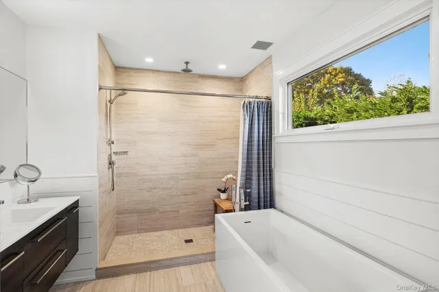 a bathroom with a bathtub and a sink