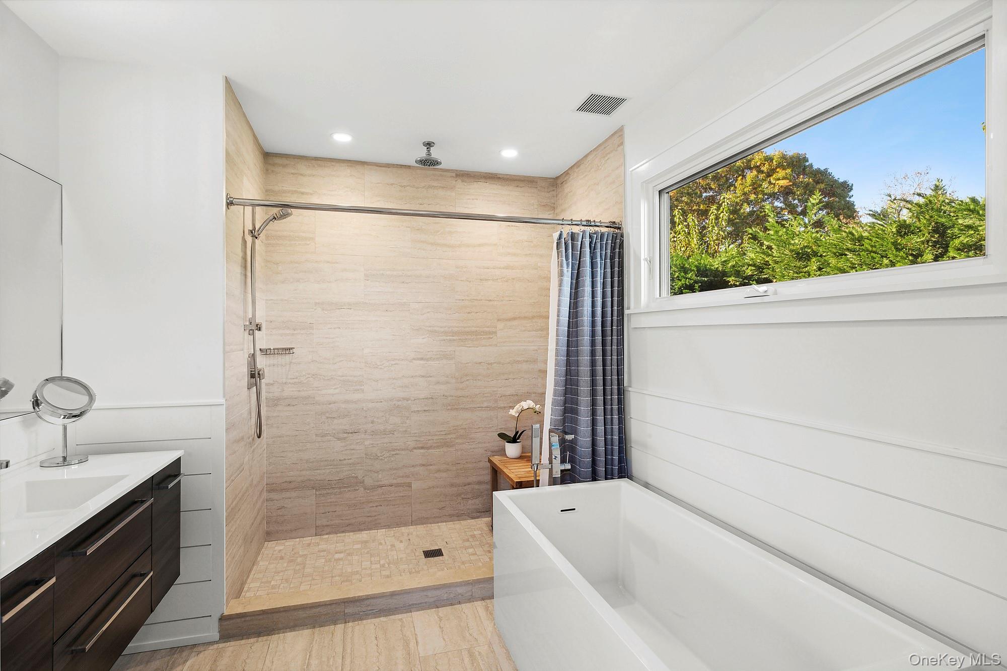 21 Cove Road Sag Harbor, NY 11963 - Photo 26 of 37 Full bathroom with a soaking tub, a stall shower, and vanity