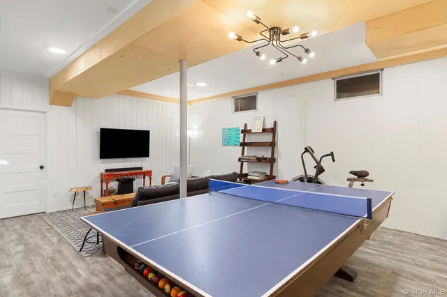 a room with pool table and a flat screen tv