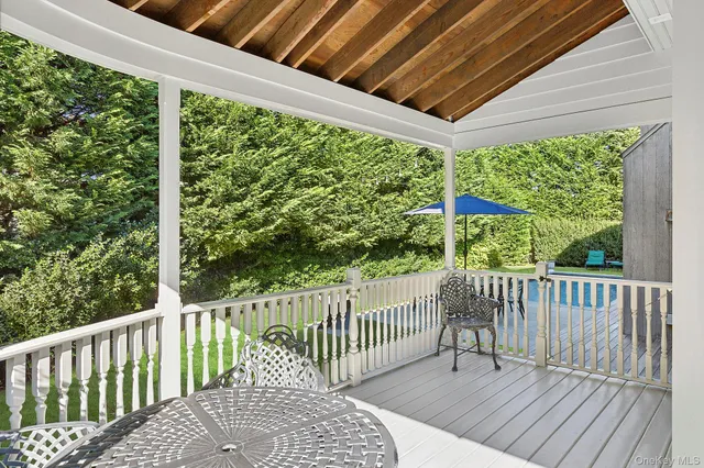 a view of a wooden deck and a backyard