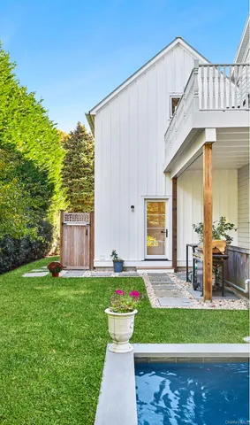 a front view of house with yard and outdoor seating