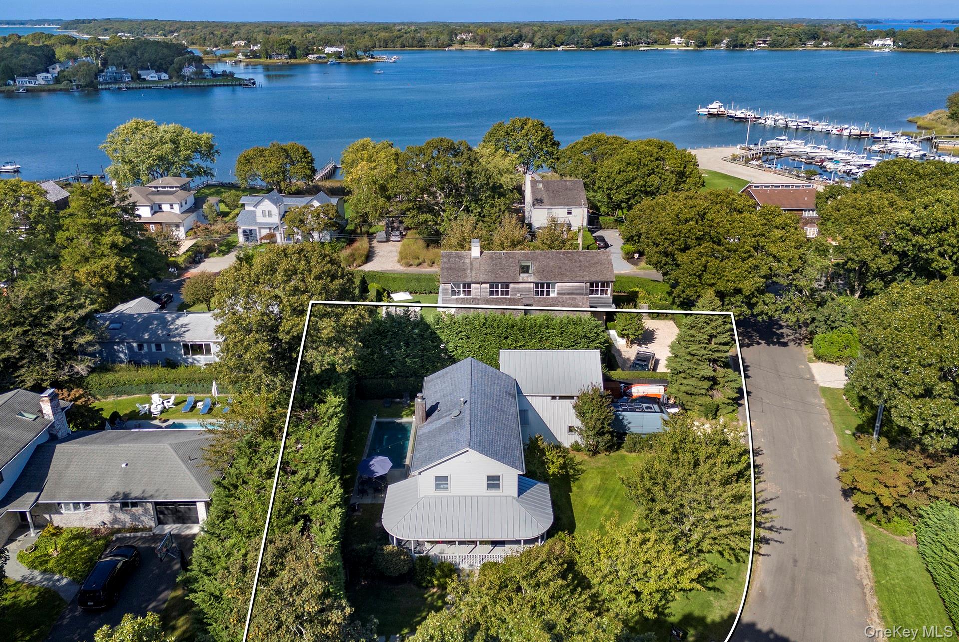 21 Cove Road Sag Harbor, NY 11963 - Photo 4 of 37 Aerial perspective of suburban area with property boundaries highlighted and a large body of water