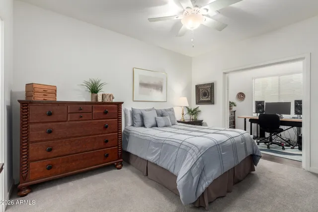 a bedroom with a bed and ceiling fan