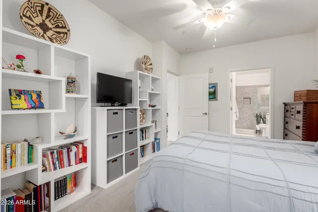 a bedroom with a bed and a book shelf