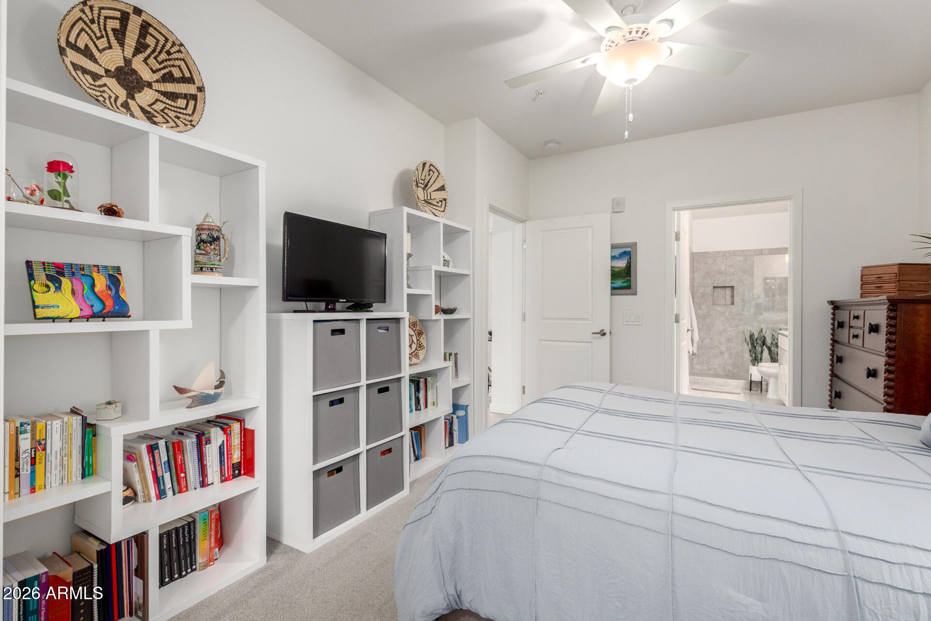 2511 West Queen Creek Road, Unit 124 Chandler, AZ 85248 - Photo 14 of 39 a bedroom with a bed and a book shelf