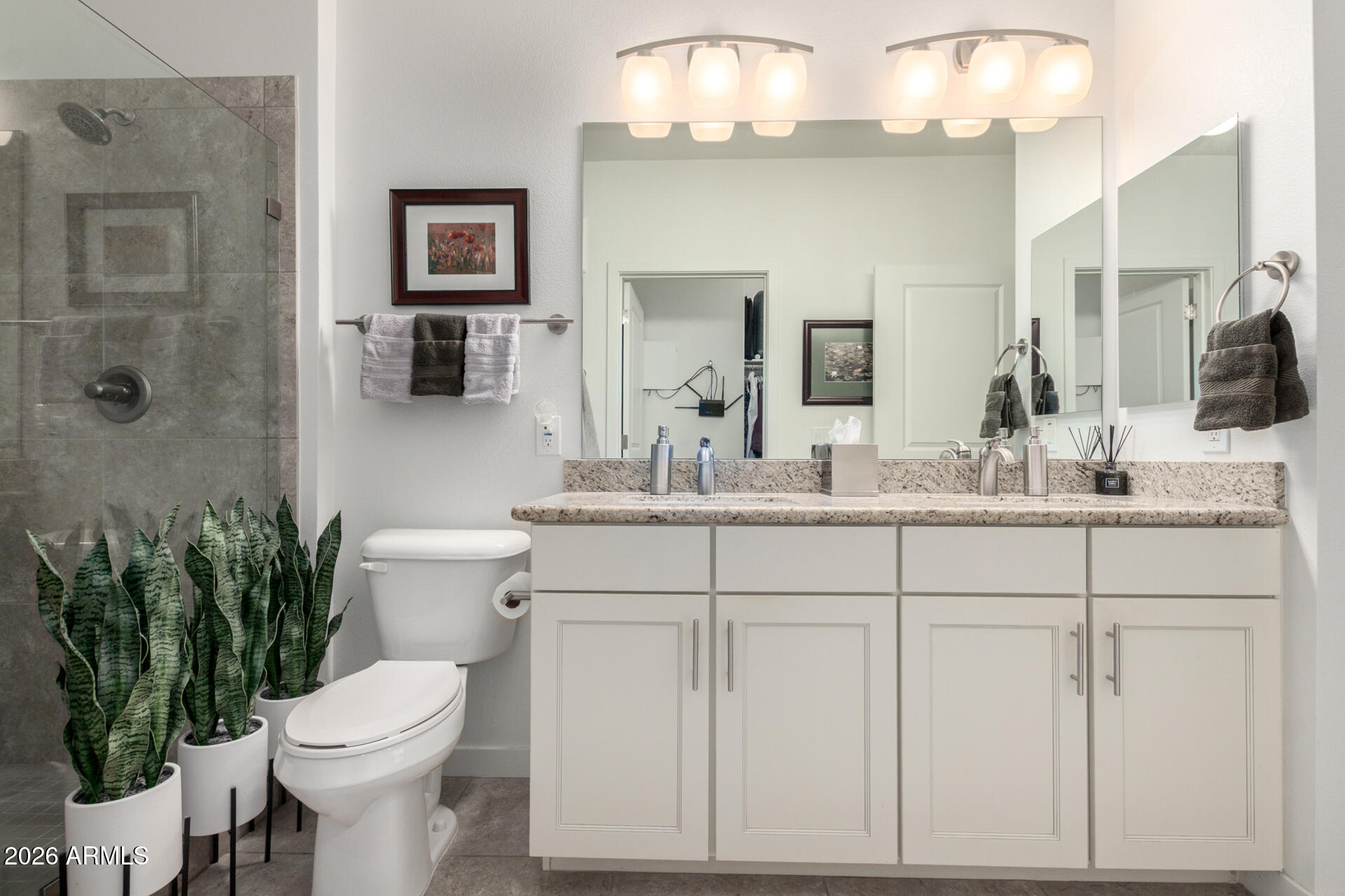 2511 West Queen Creek Road, Unit 124 Chandler, AZ 85248 - Photo 15 of 39 a bathroom with a toilet sink and mirror