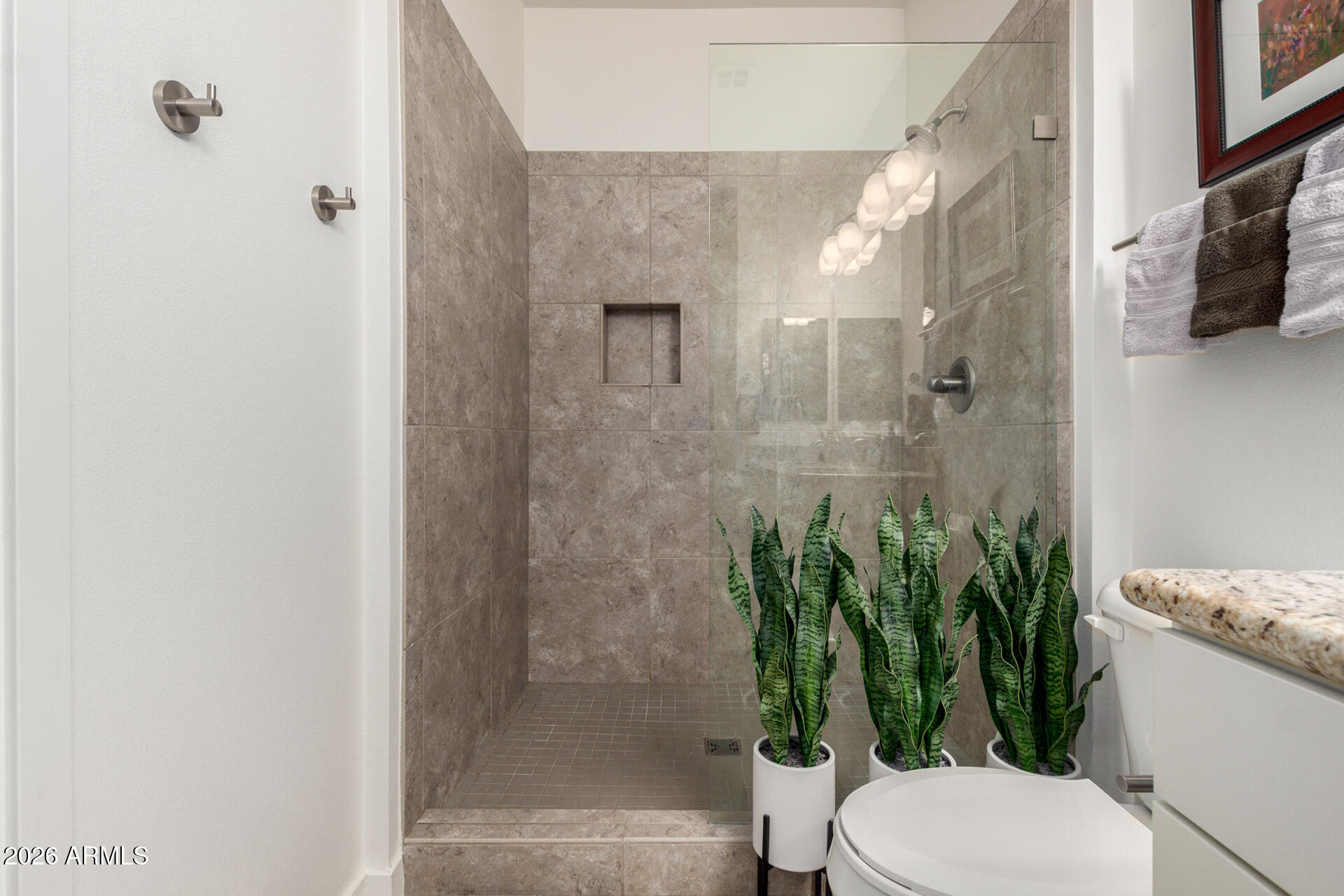 2511 West Queen Creek Road, Unit 124 Chandler, AZ 85248 - Photo 16 of 39 a bathroom with a toilet a sink and shower