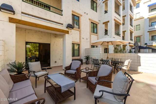a view of a patio with a table and chairs