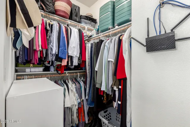 a view of walk in closet with clothes