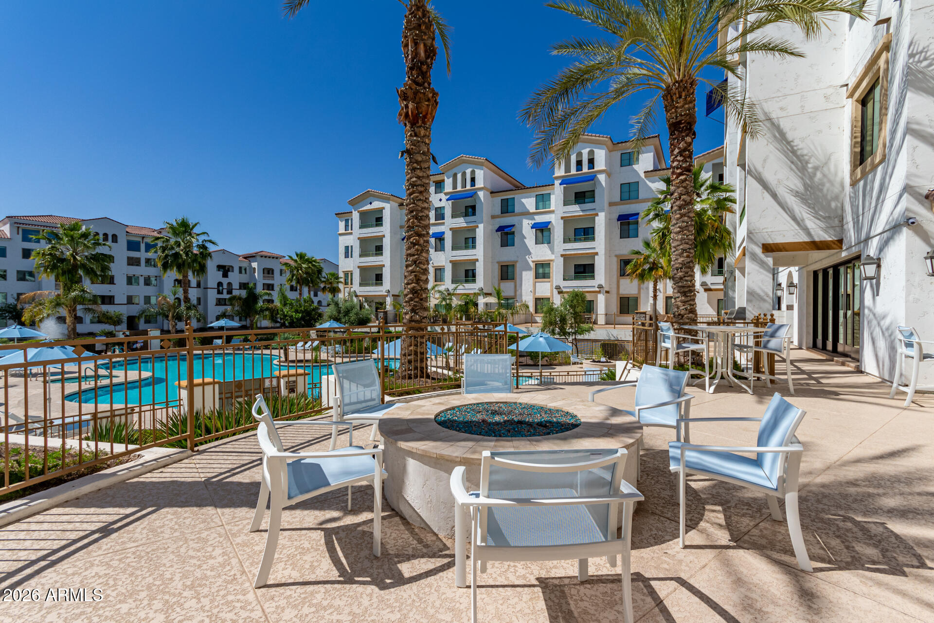 2511 West Queen Creek Road, Unit 124 Chandler, AZ 85248 - Photo 27 of 39 a view of a chairs and table in patio with a lake view