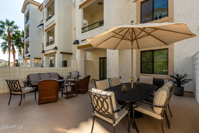 a couple of chairs and a table in the patio