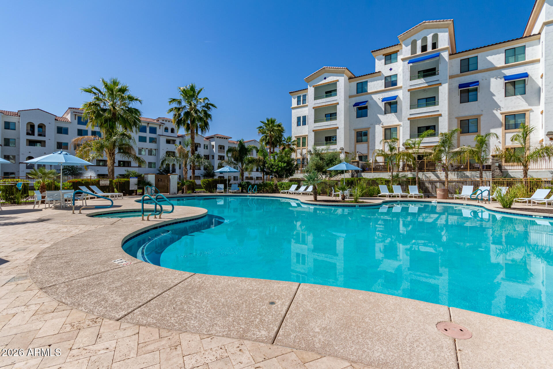 2511 West Queen Creek Road, Unit 124 Chandler, AZ 85248 - Photo 33 of 39 a view of swimming pool with outdoor seating and plants