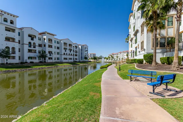 a view of a lake with a building and a big yard
