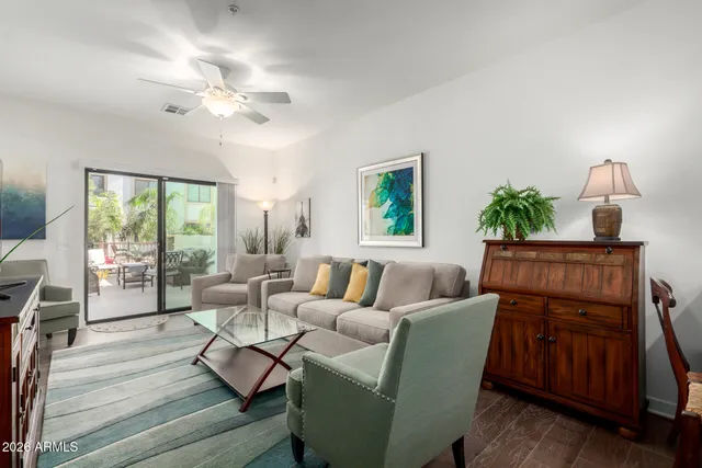 a living room with furniture and a lamp