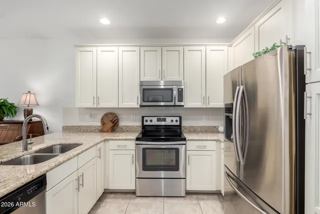 a kitchen with a refrigerator stove and sink
