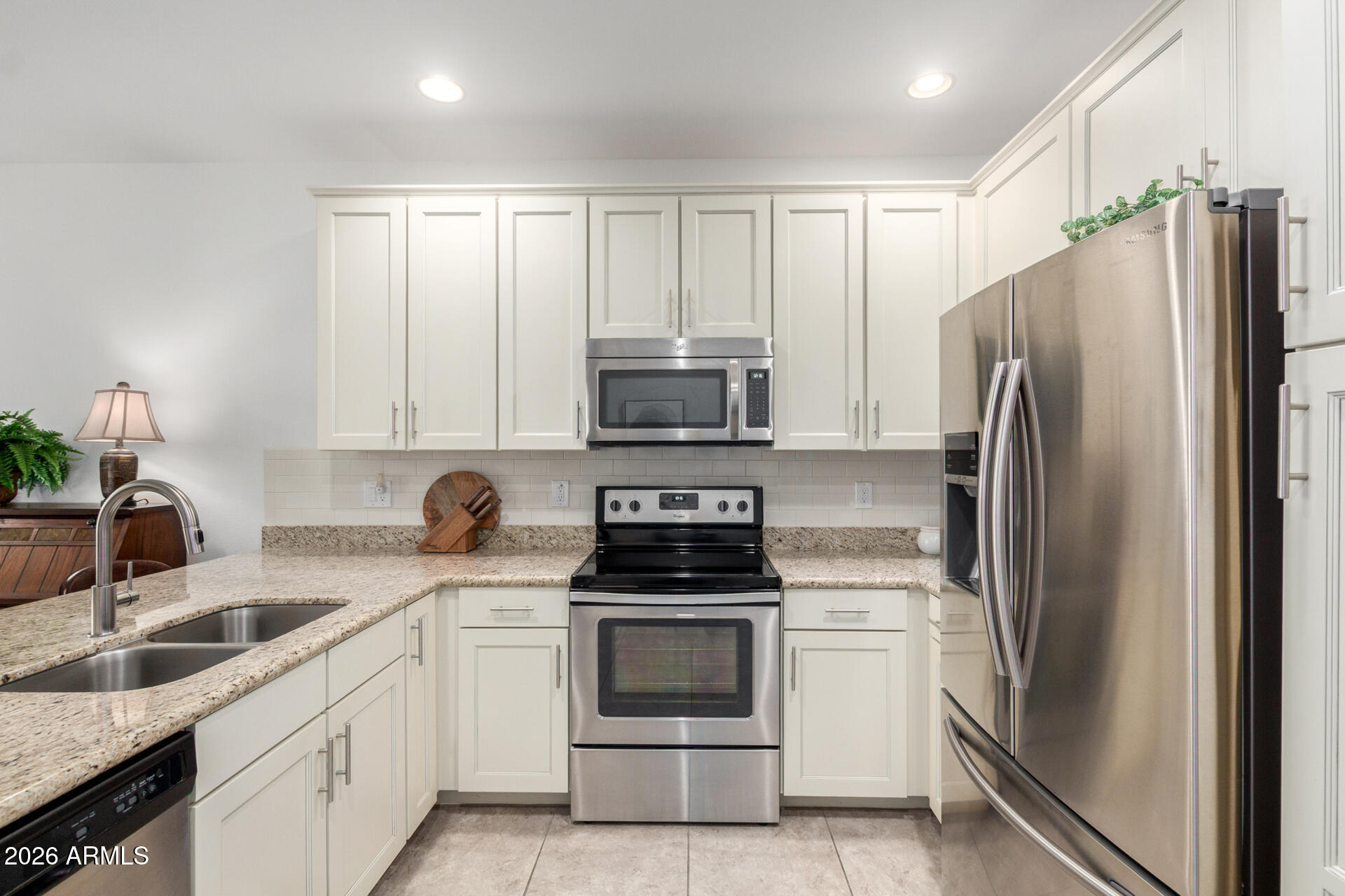 2511 West Queen Creek Road, Unit 124 Chandler, AZ 85248 - Photo 6 of 39 a kitchen with a refrigerator stove and sink