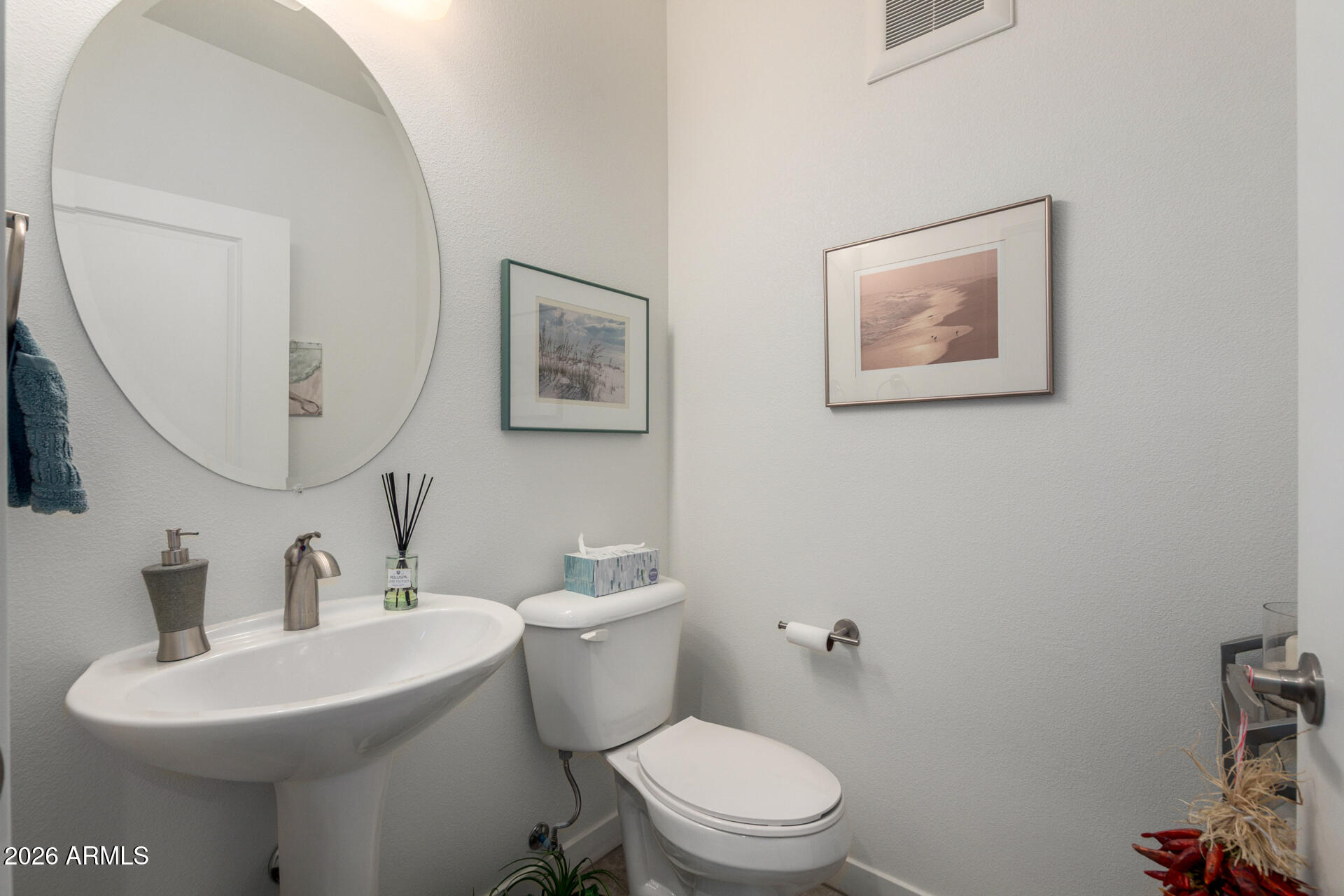 2511 West Queen Creek Road, Unit 124 Chandler, AZ 85248 - Photo 10 of 39 a bathroom with a toilet a sink and mirror