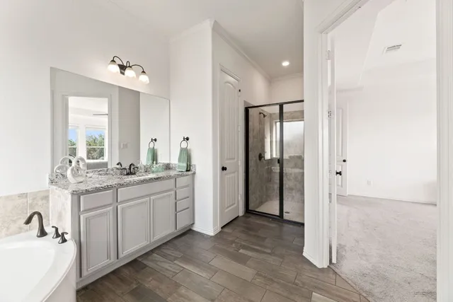 a bathroom with a double vanity sink mirror and shower