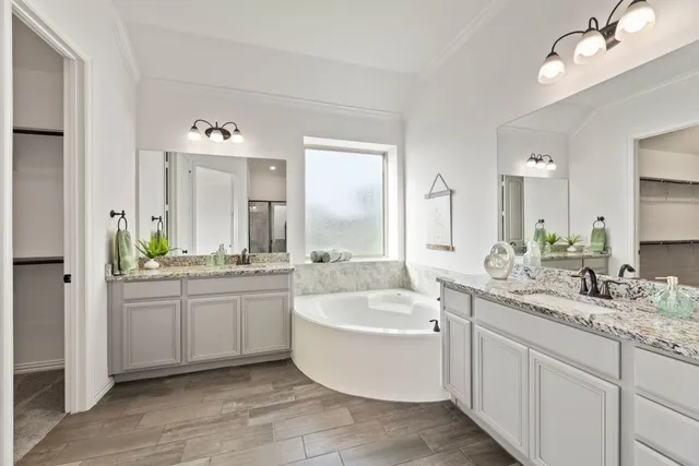 a spacious bathroom with a granite countertop tub sink and mirror