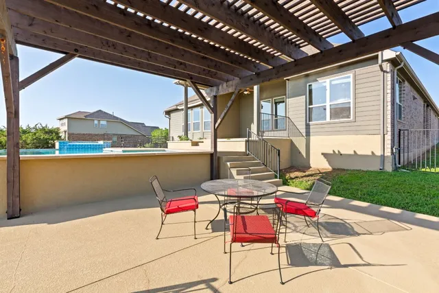 a building outdoor space with patio furniture and garden view