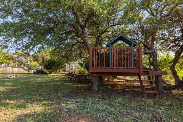 a view of a house with backyard and sitting area