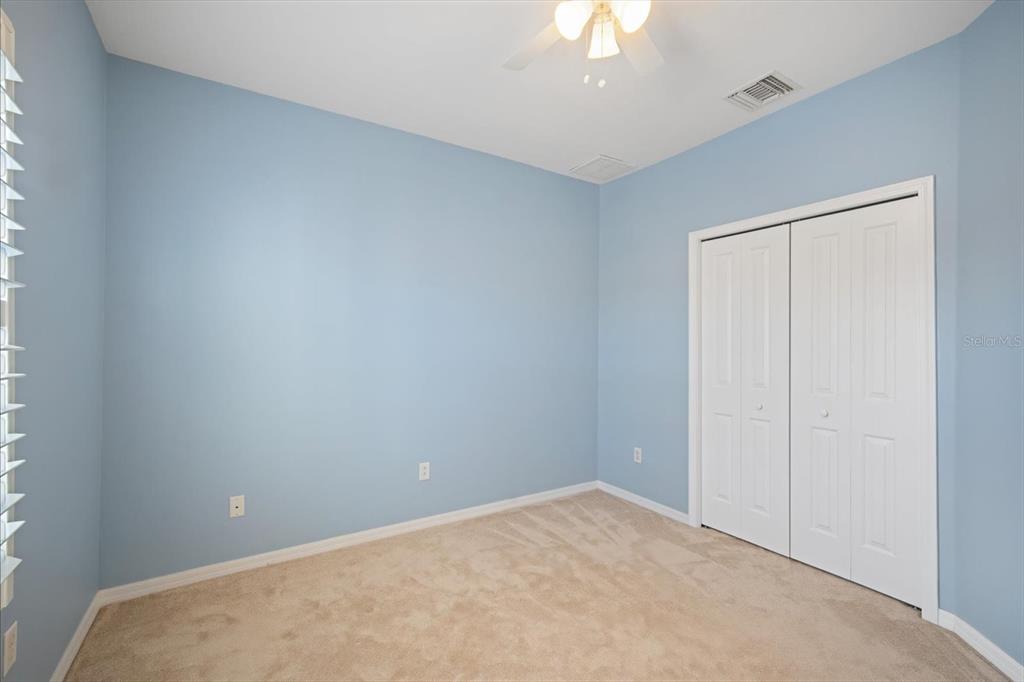 6142 Hadley Commons Drive Riverview, FL 33578 - Photo 14 of 29 an empty room with a chandelier fan