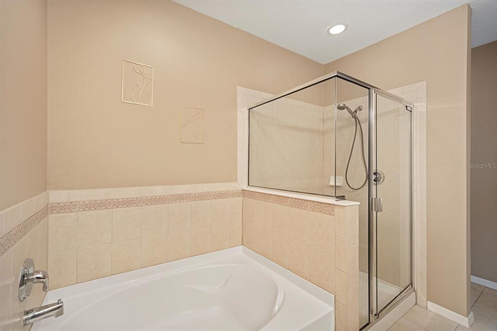 6142 Hadley Commons Drive Riverview, FL 33578 - Photo 19 of 29 a bathroom with a shower and a glass door