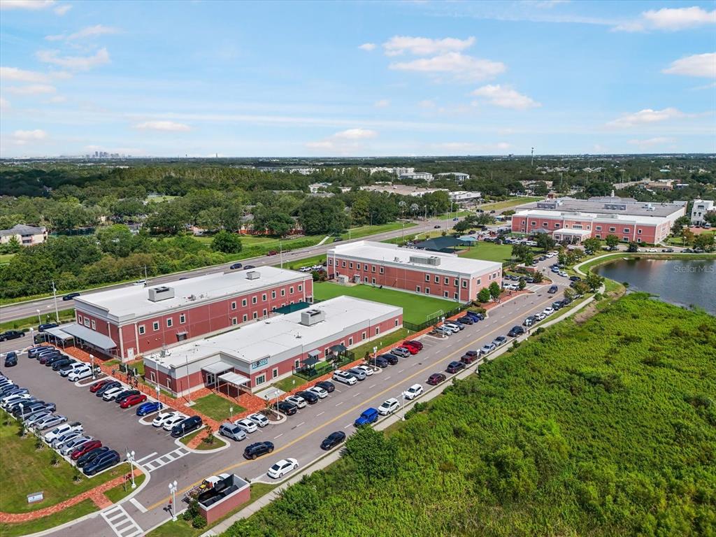 6142 Hadley Commons Drive Riverview, FL 33578 - Photo 28 of 29 an aerial view of a city with lots of residential buildings ocean and mountain view in back