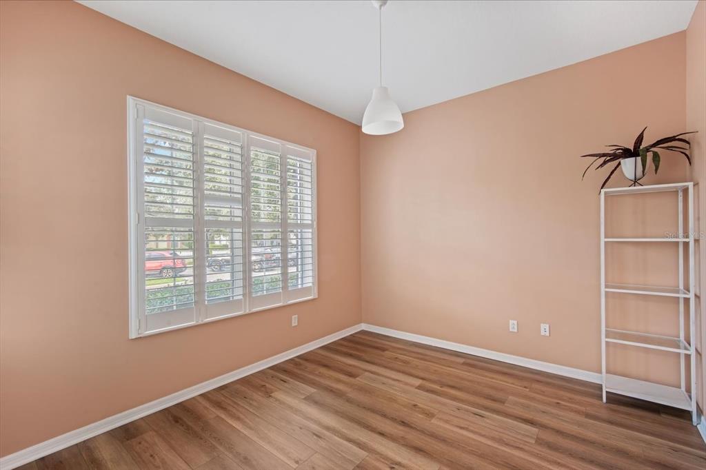 6142 Hadley Commons Drive Riverview, FL 33578 - Photo 3 of 29 a view of an empty room with a window and wooden floor