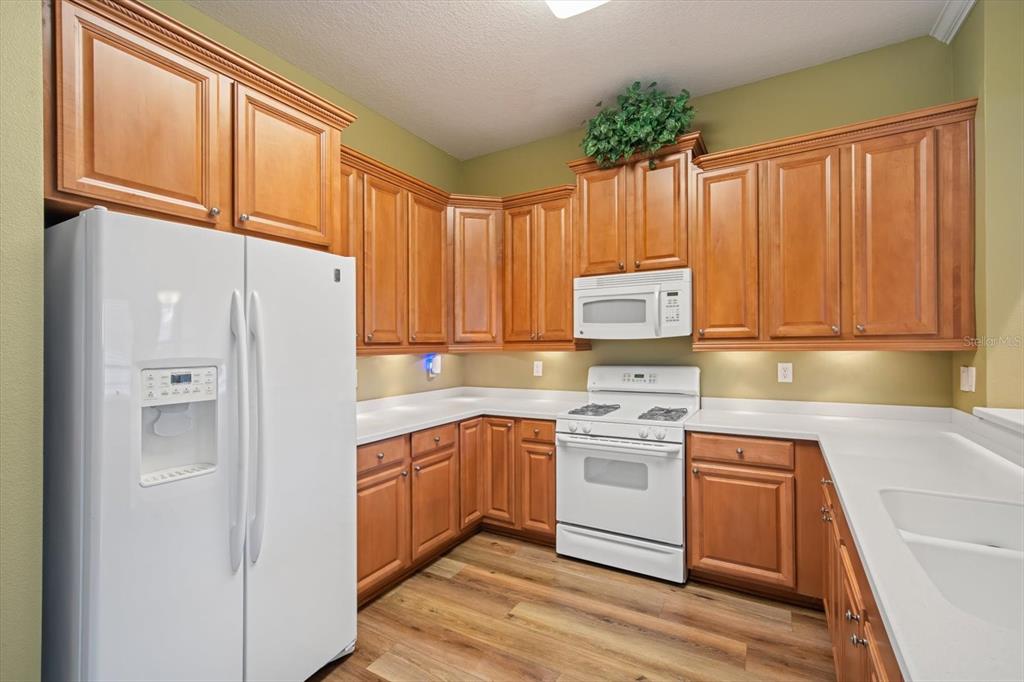 6142 Hadley Commons Drive Riverview, FL 33578 - Photo 5 of 29 a kitchen with a white cabinets and white appliances