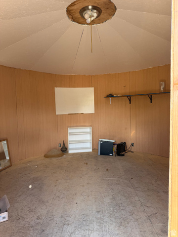 255 E Centre Spring City, UT 84662 - Photo 30 of 34 Room featuring light wood-finish wall paneling, a circular ceiling with a central flush-mount light fixture, and light-toned flooring
