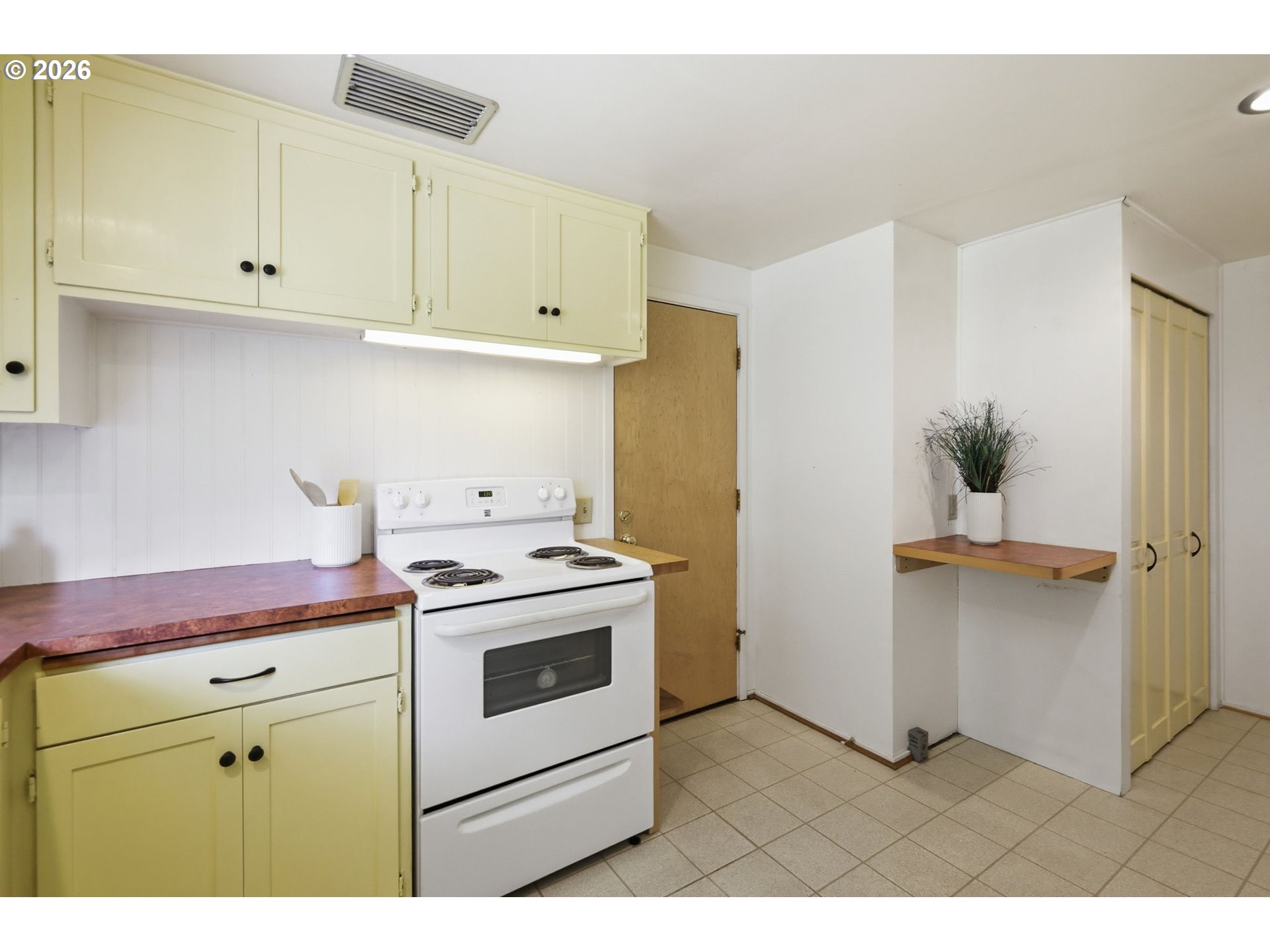 3025 Harris Street Eugene, OR 97405 - Photo 20 of 44 a kitchen with white cabinets and white appliances
