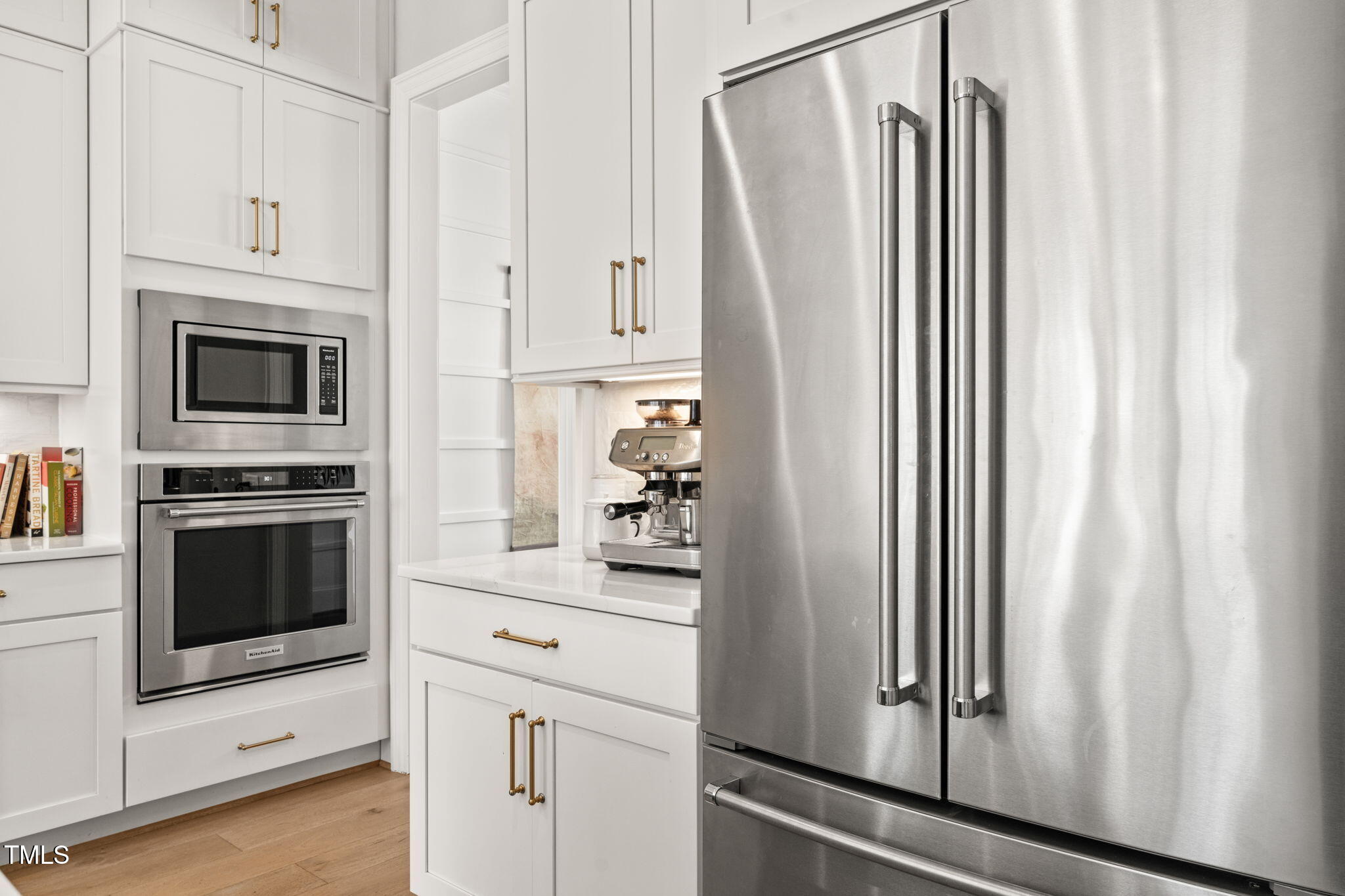 2105 Gardenbrook Drive Raleigh, NC 27606 - Photo 14 of 86 a kitchen with white cabinets and white appliances