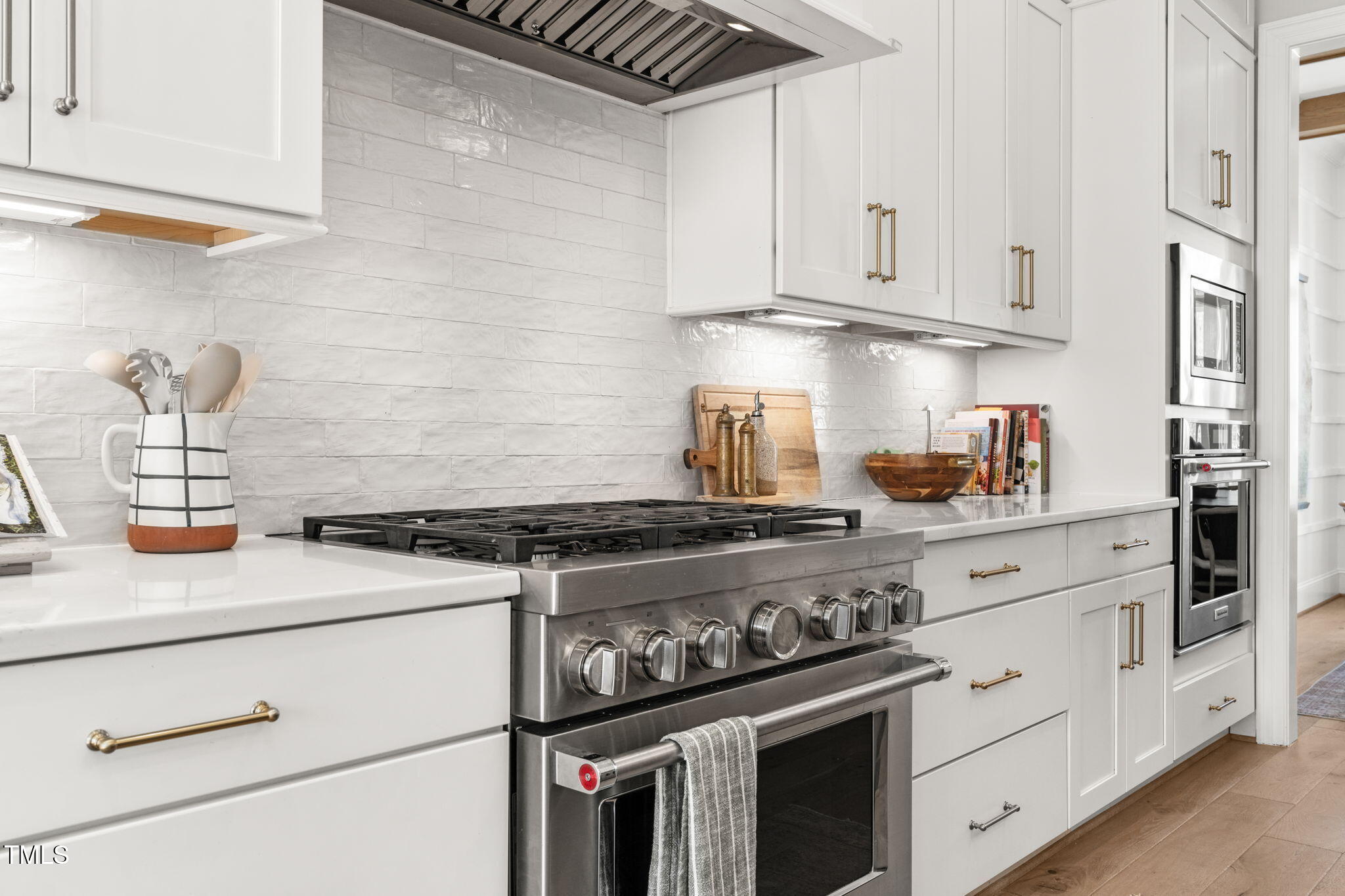 2105 Gardenbrook Drive Raleigh, NC 27606 - Photo 15 of 86 a kitchen with white cabinets and appliances