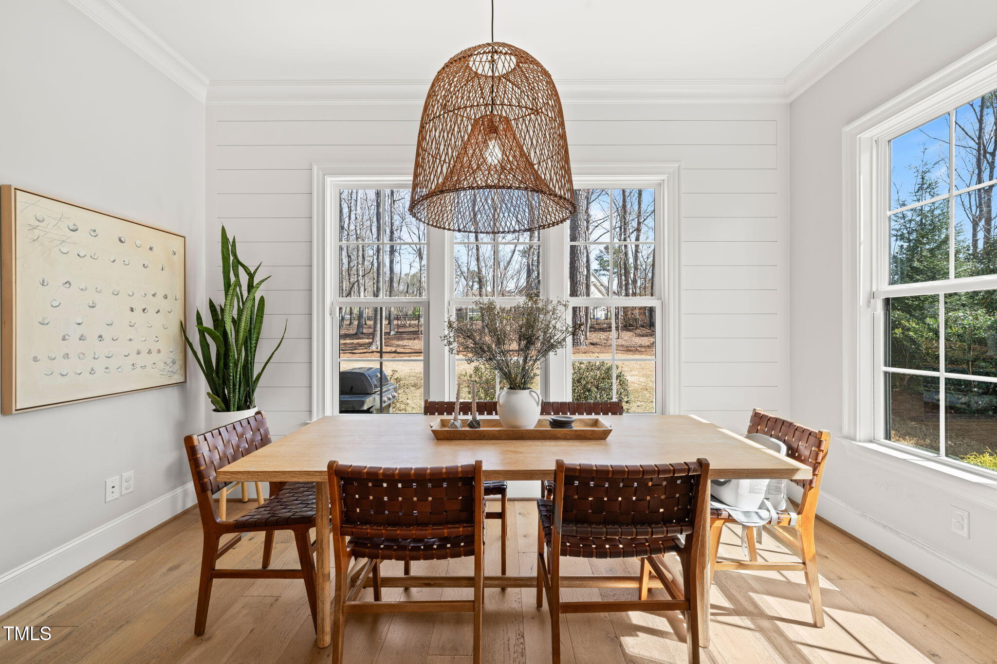2105 Gardenbrook Drive Raleigh, NC 27606 - Photo 19 of 86 a dining room with furniture a chandelier and wooden floor