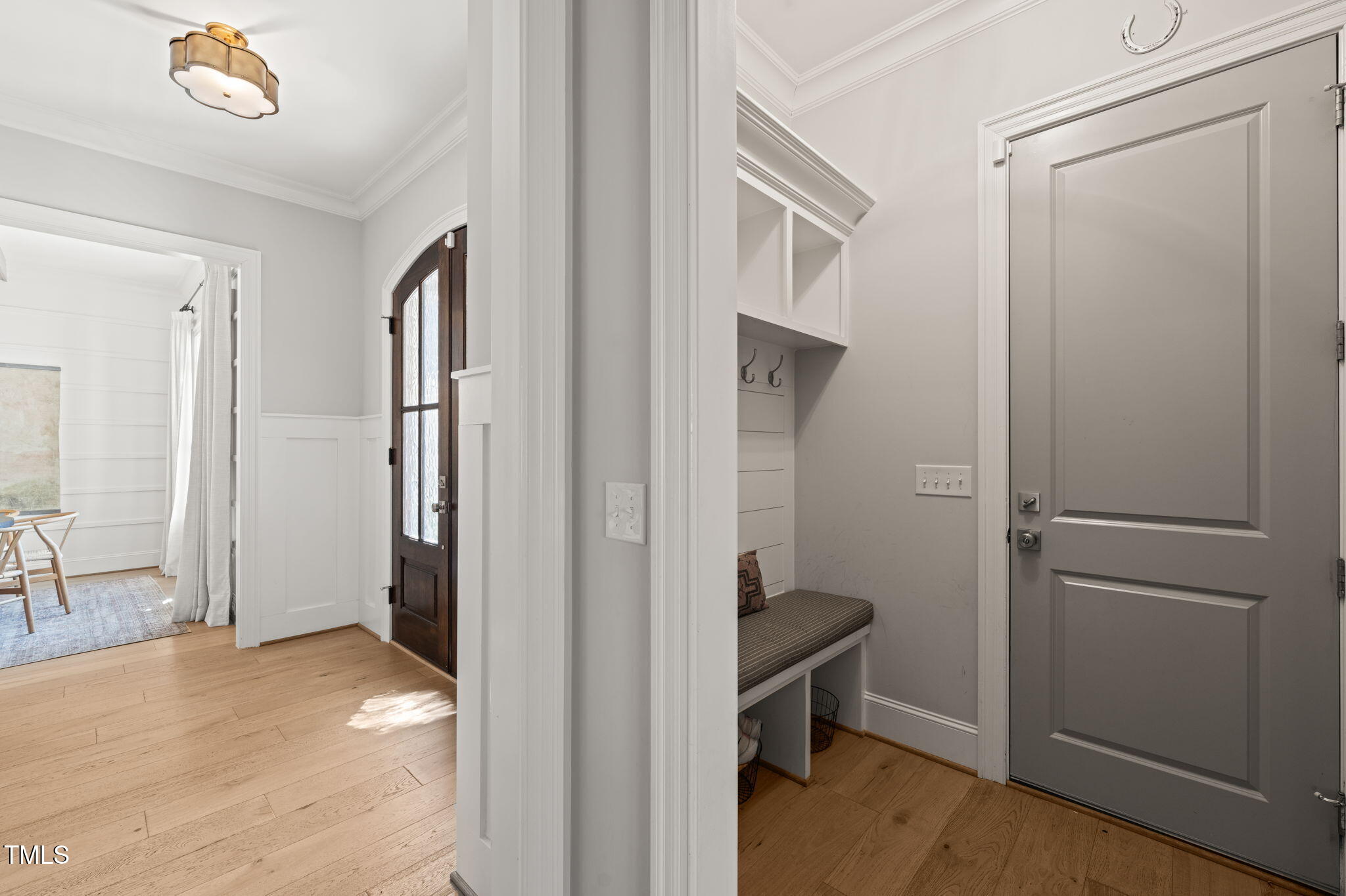 2105 Gardenbrook Drive Raleigh, NC 27606 - Photo 27 of 86 a view of a hallway with wooden floor and a livingroom