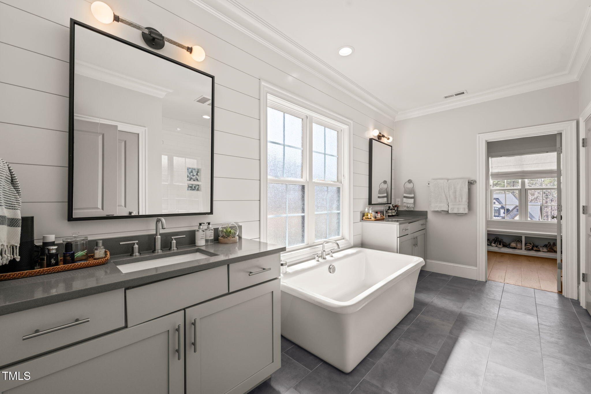 2105 Gardenbrook Drive Raleigh, NC 27606 - Photo 37 of 86 a spacious bathroom with a double vanity sink a mirror and a bathtub