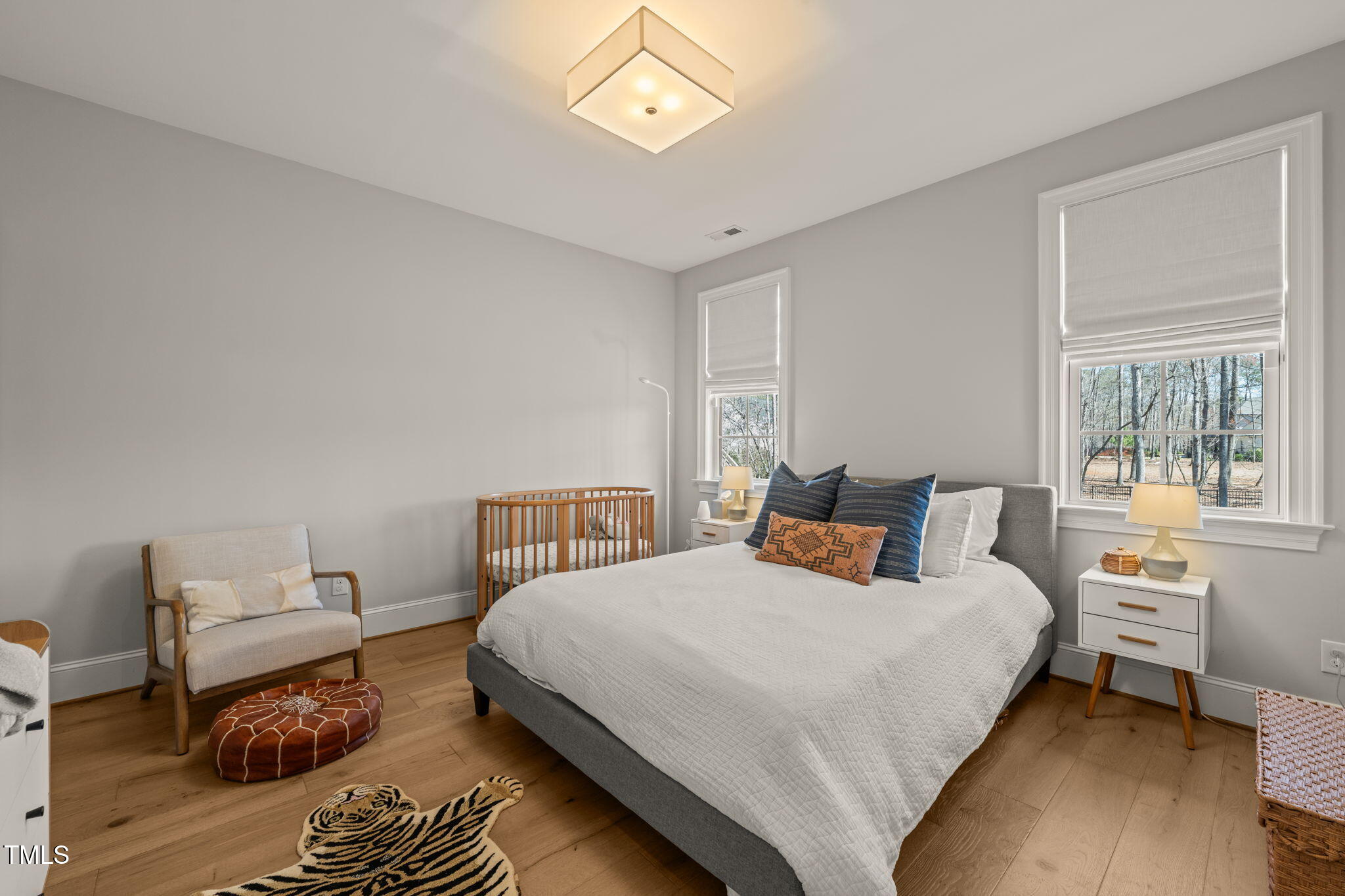 2105 Gardenbrook Drive Raleigh, NC 27606 - Photo 42 of 86 a bedroom with a bed and wooden floor