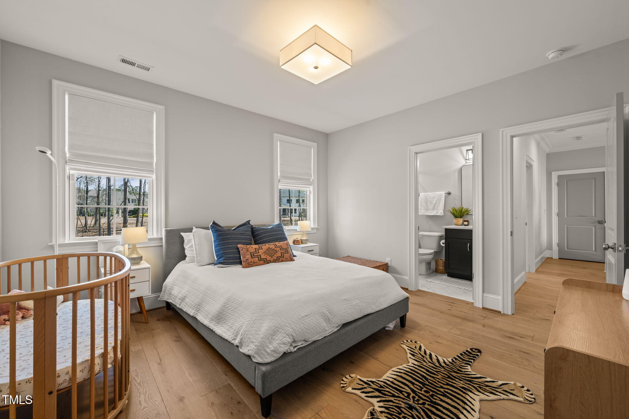 2105 Gardenbrook Drive Raleigh, NC 27606 - Photo 43 of 86 a bedroom with a bed and a chandelier