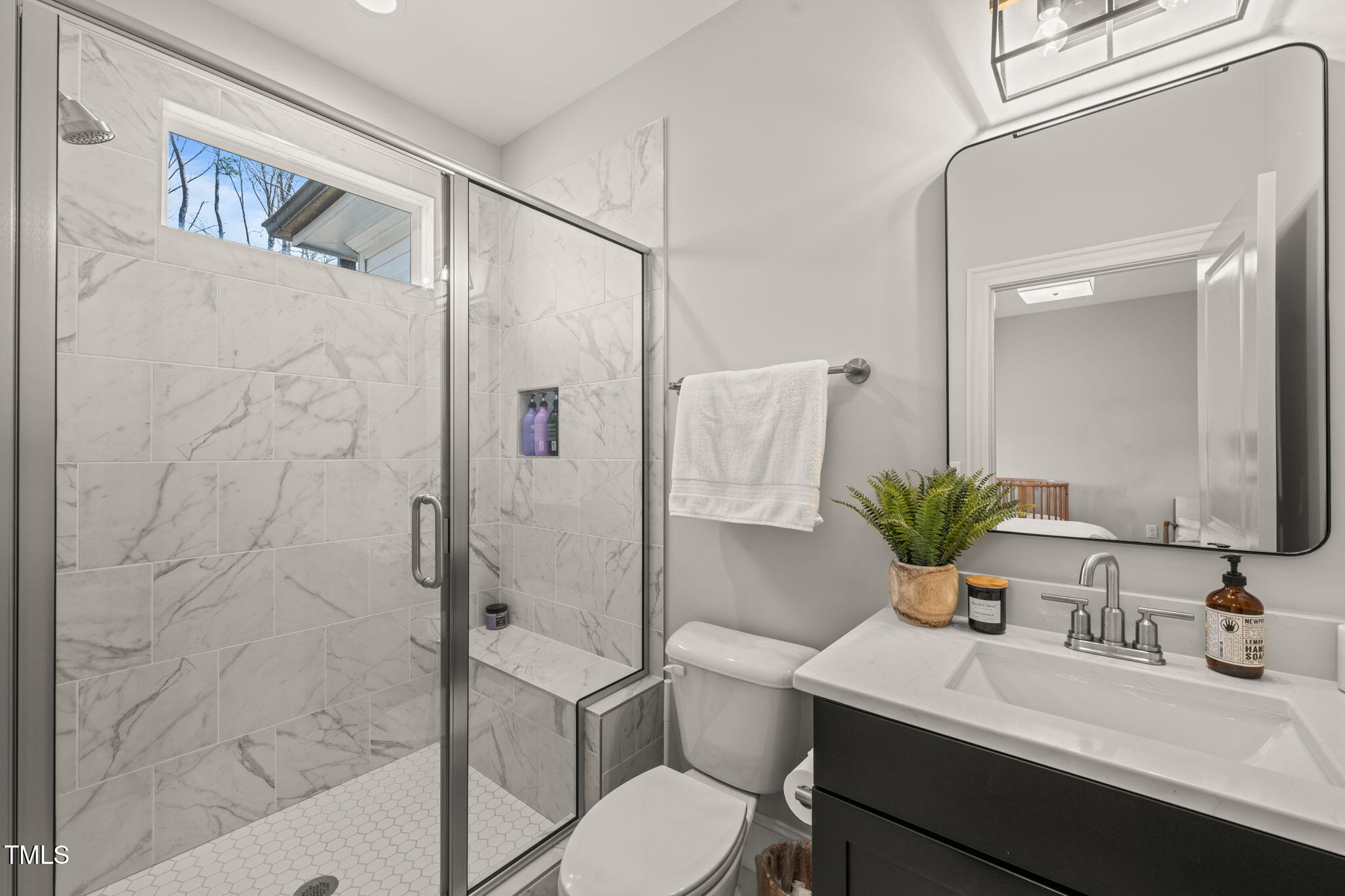 2105 Gardenbrook Drive Raleigh, NC 27606 - Photo 44 of 86 a bathroom with a granite countertop sink toilet a large mirror a shower and a bathtub