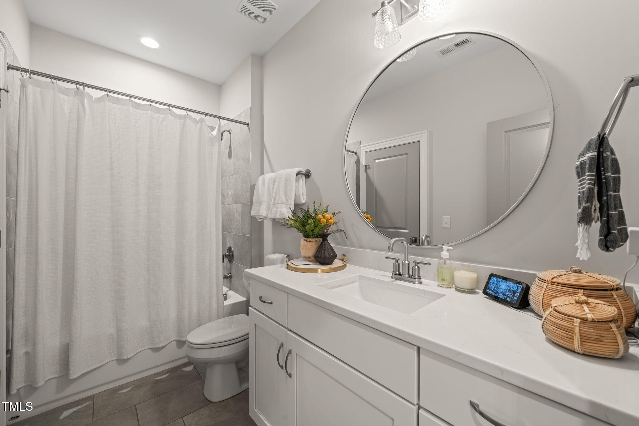 2105 Gardenbrook Drive Raleigh, NC 27606 - Photo 48 of 86 a bathroom with a sink a toilet and shower curtain