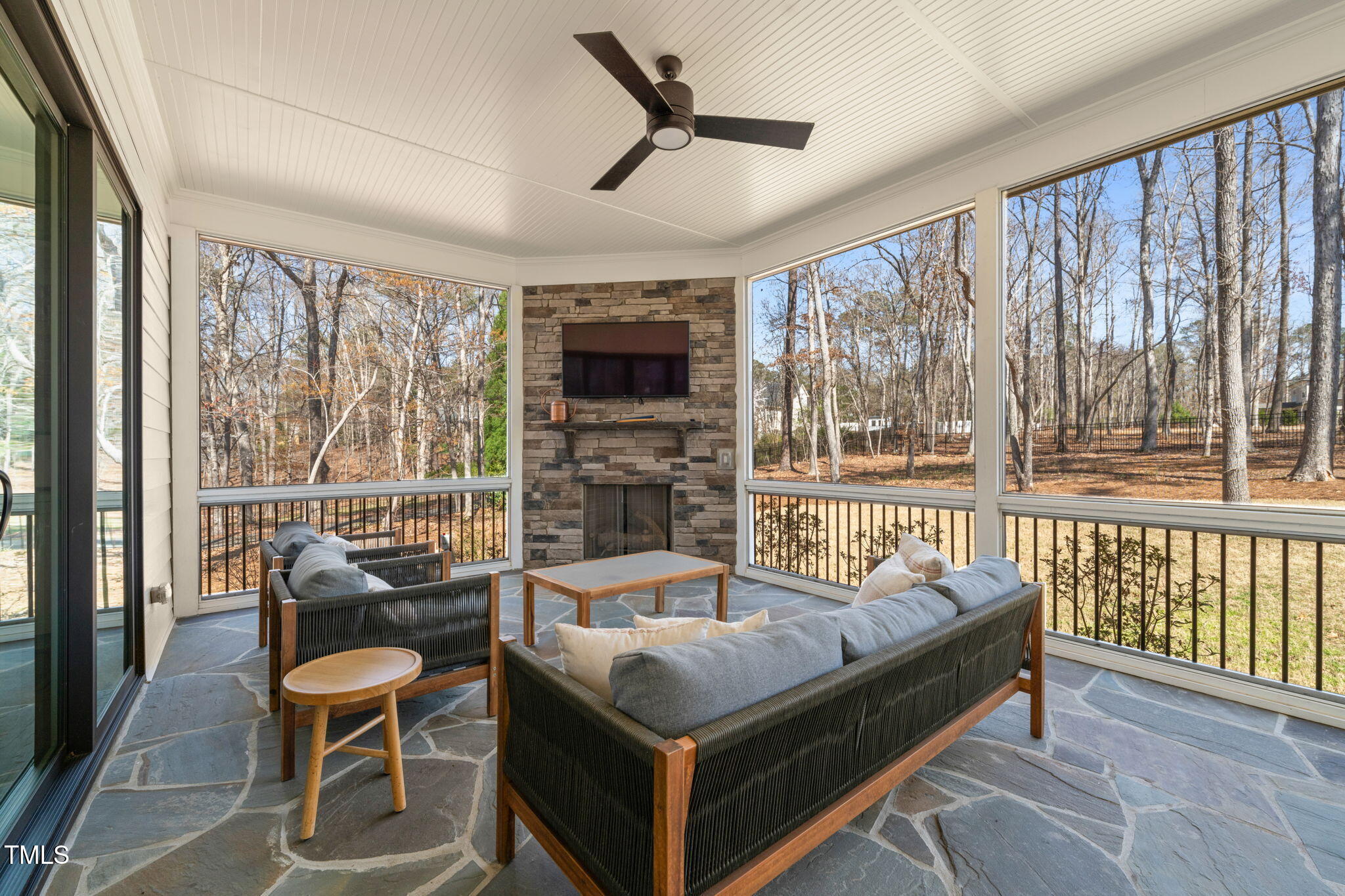 2105 Gardenbrook Drive Raleigh, NC 27606 - Photo 54 of 86 a living room with furniture a flat screen tv and a floor to ceiling window