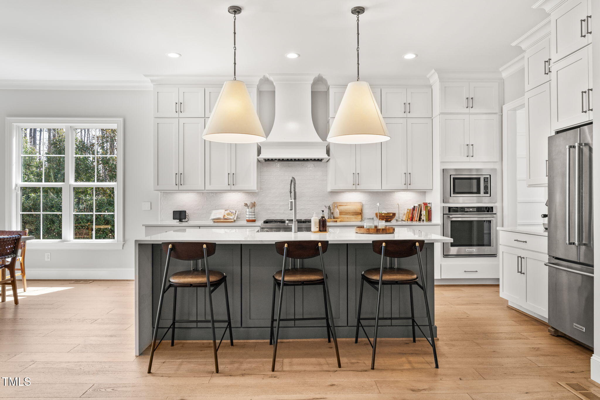 2105 Gardenbrook Drive Raleigh, NC 27606 - Photo 9 of 86 a kitchen with stainless steel appliances granite countertop a table chairs stove a refrigerator and a view of living room