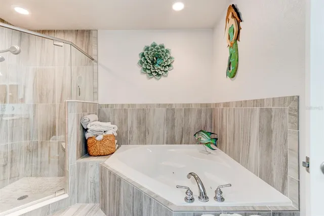 a bath tub sitting next to a shower