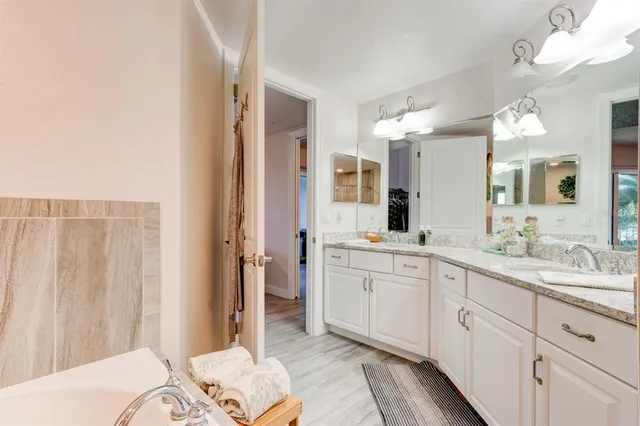 a spacious bathroom with a double vanity sink mirror and