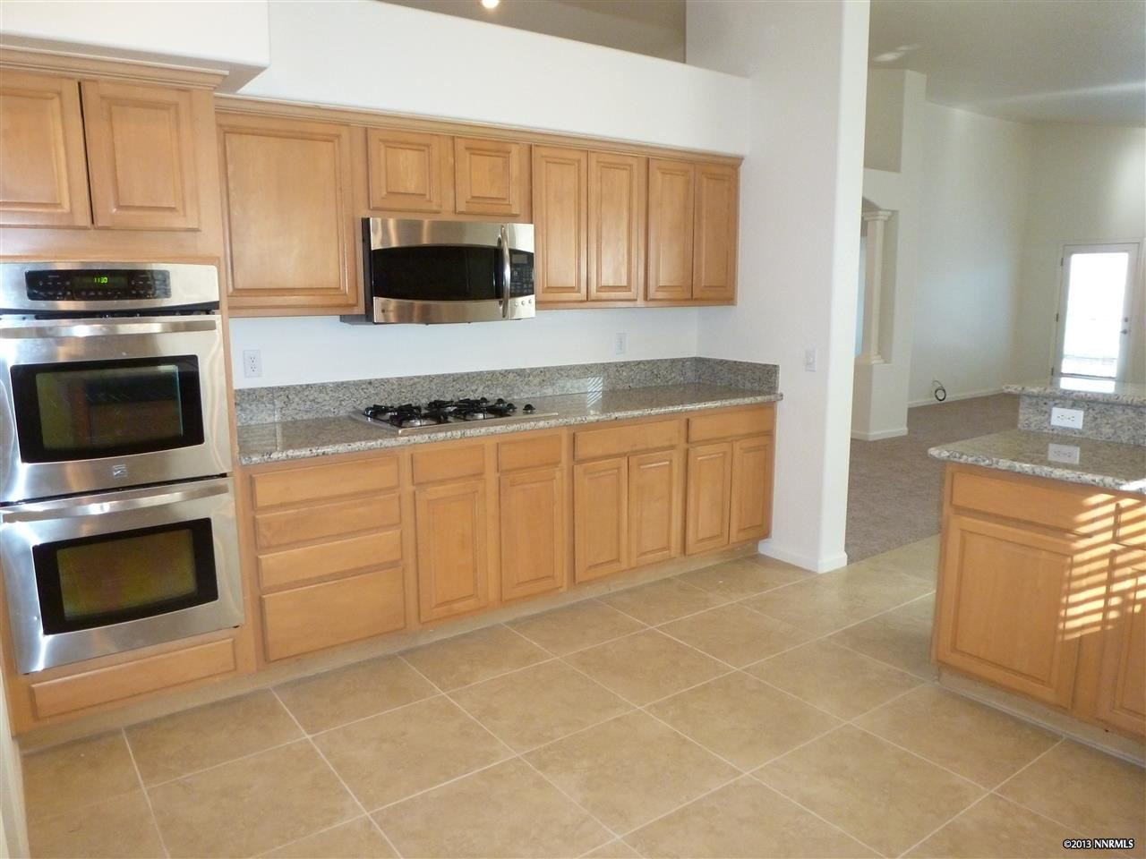 2550 Granite Springs Road Reno, NV 89519 - Photo 1 of 1 a kitchen with stainless steel appliances granite countertop a stove a sink and a microwave