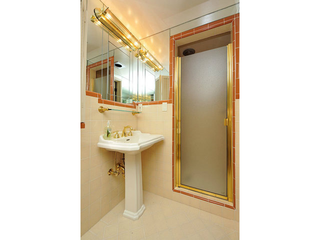 259 Bridge Road Hillsborough, CA 94010 - Photo 16 of 23 a bathroom with a sink a mirror and a window