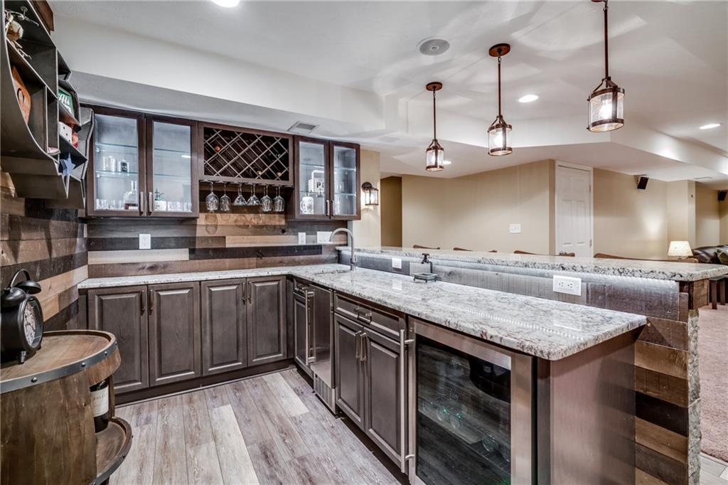 2018 Eagle Ridge Drive Valencia, PA 16059 - Photo 11 of 25 Thoughtfully designed, this granite bar with wood plank walls has it all...Plenty of storage, a beverage fridge, ice maker, wine rack, etc.!