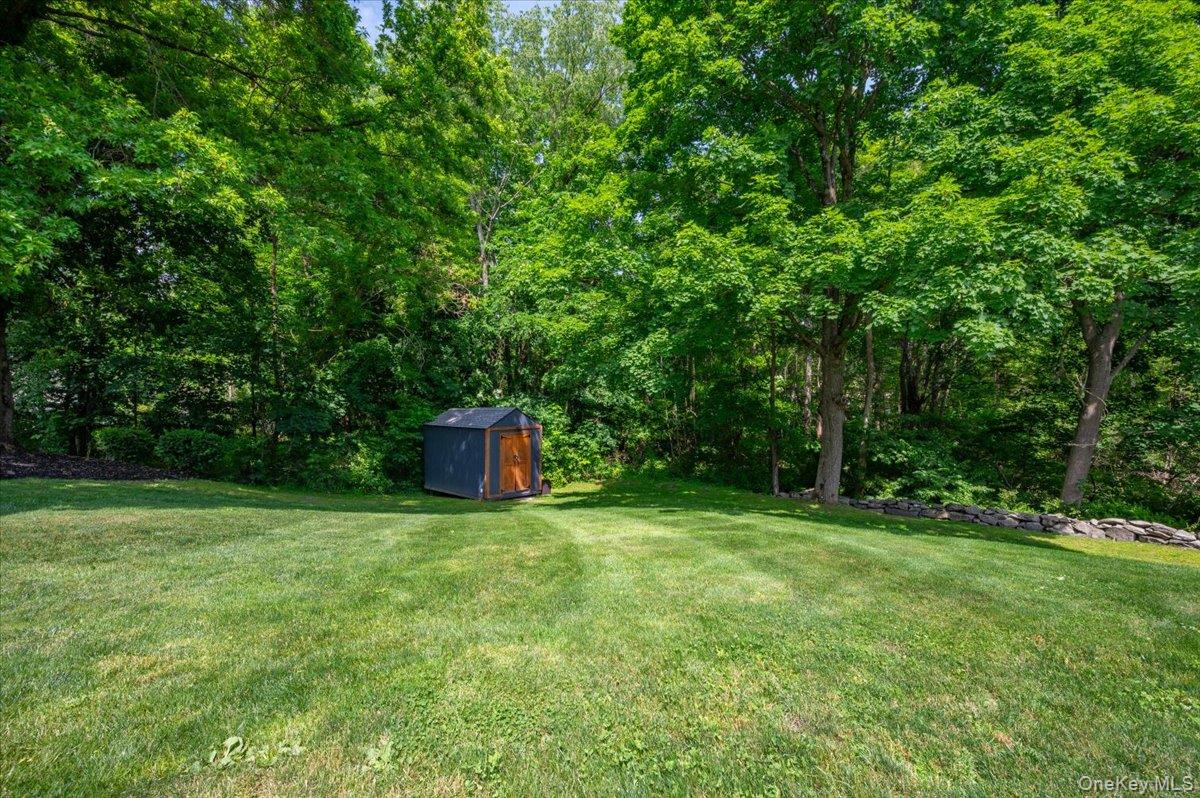 13 Jacks Pond Road Newburgh, NY 12550 - Photo 37 of 44 Expansive lawn with lush green grass and mature trees providing natural screening.
